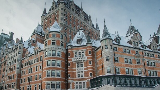 A historic building with a distinctive architectural style, featuring multiple towers and a prominent central tower. - PLACE DES ARTS / ART'S PLACE (Ville de Québec)