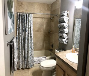 Combined shower/tub, hair dryer, towels, soap