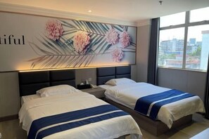 A hotel room with two beds, a nightstand, a wall-mounted lamp, and a large window with a city view.