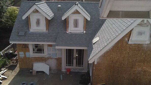 A two-story house with a gabled roof, dormer windows, and a visible front door. - Brand New Cottage In Great Berkeley Neighborhood.  (Berkeley)