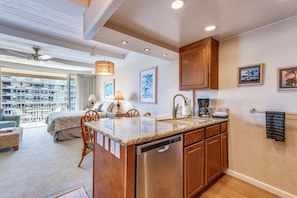 A modern kitchen with a central island, wooden cabinets, and a dishwasher.