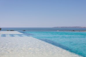 A clear view of a swimming pool with a view of the sea and distant land. - Longevity Health and Wellness Hotel - Adults Only (Portimão)