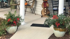 A porch with a snowman decoration, potted plants, and outdoor seating. - Relax in a Peaceful Country Home in the Blue Ridge Mountains. Enjoy Local Events (Sparta)