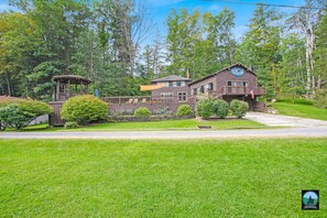 Surrounded by lush greenery, this rustic lodge offers a tranquil retreat amidst the forest.