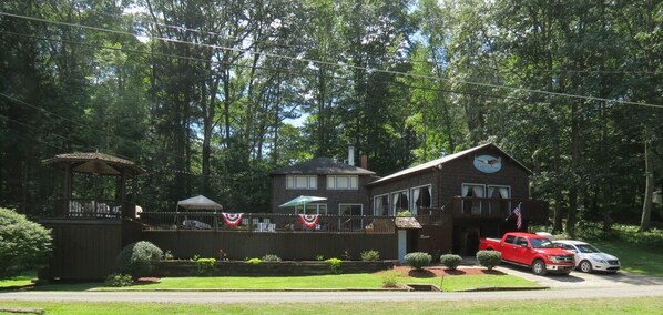 Experience a serene, natural setting with a central clock tower and lush greenery surrounding this charming property.