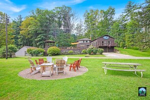 Escape to a peaceful retreat surrounded by lush trees and a beautifully manicured lawn.