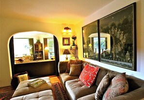 Relax in this inviting living room with a comfortable sofa set and a beautiful framed artwork.
