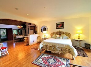 Experience a classic retreat with a large bed, ornate headboard, and cozy sitting area.