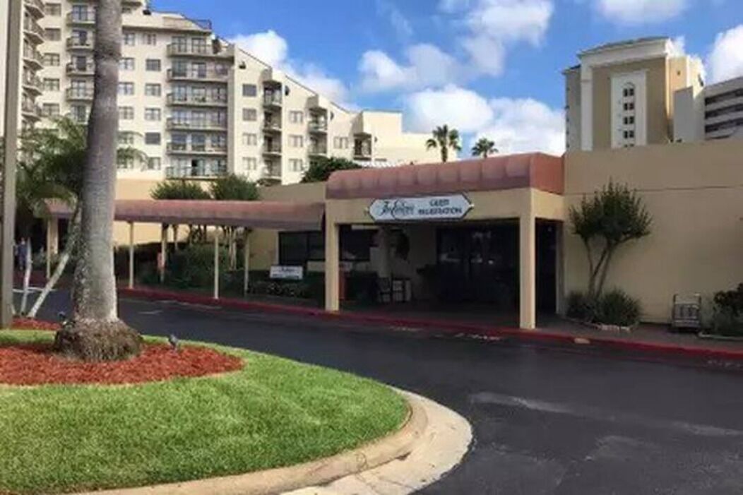 A hotel with a sign reading "Hotel El Cortez".