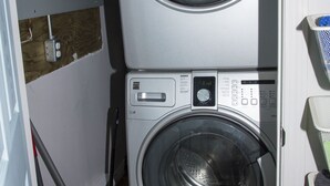 A laundry room with two stacked front-loading washing machines and a dryer. - Lakefront Cottage in Manitou Beach - Three Bedroom Cottage, Sleeps 8 (Manitou Beach)