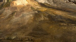 A large rock formation with a flat surface in front.