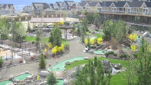 A resort with a pool area, outdoor seating, and a view of the ocean. - Private Lake View Cottage with amenities for everyone! (Kelowna)