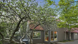 A modern house with a sloped roof, large windows, and a gravel driveway. - Maple View Medlow Bath, Blue Mountains (Medlow Bath)