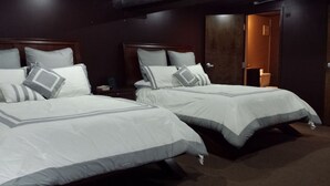 Two double beds with grey and white bedding, wooden headboards, and a dark brown carpet. - Up to 50% off for limited time! Professionally Cleaned, Pool & Foosball Table (Nashville)