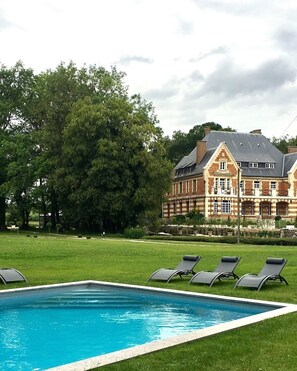 Seasonal outdoor pool, open 10:00 AM to 8:00 PM, pool loungers