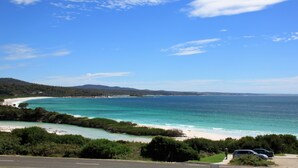 A coastal road with a beach and ocean view.