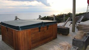A wooden hot tub on a wooden deck with a view of the ocean. - Relax in the Wanganui Dunes (Wanganui Township)