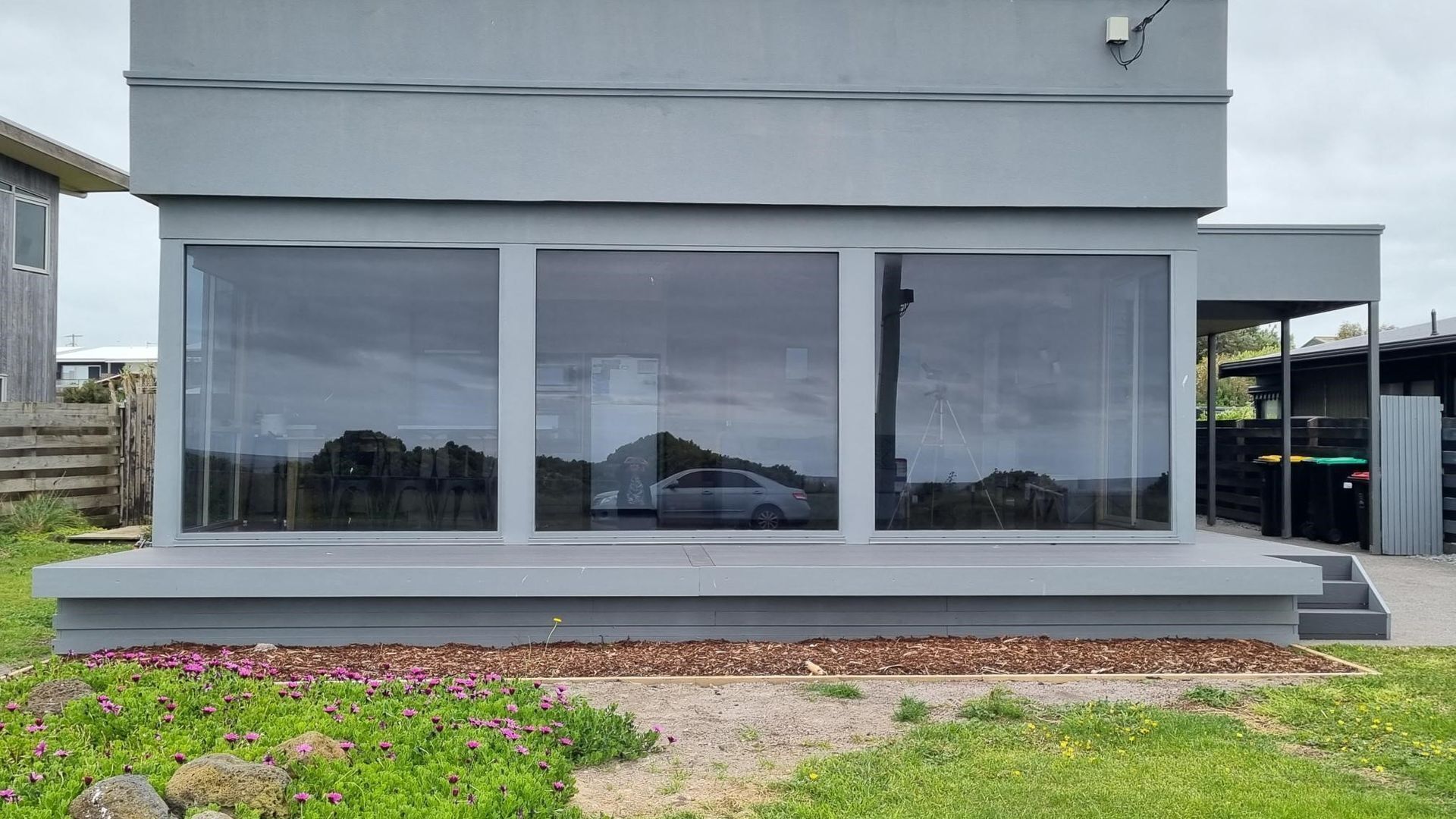Een modern gebouw met grote ramen en een plat dak.