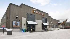 A large building with a sign reading "Market & Eatery" and a "Fresh Brew" sign.