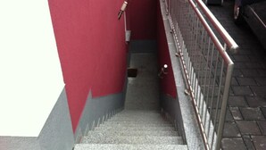 A staircase with a metal railing, leading to a lower level. - Appartements Funk (Pfungstadt)
