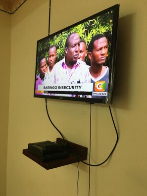 Enjoy in-room entertainment with a mounted TV and convenient shelf for your devices.