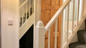 A staircase with white railings and a wooden door. - Highfield University House (Southampton)