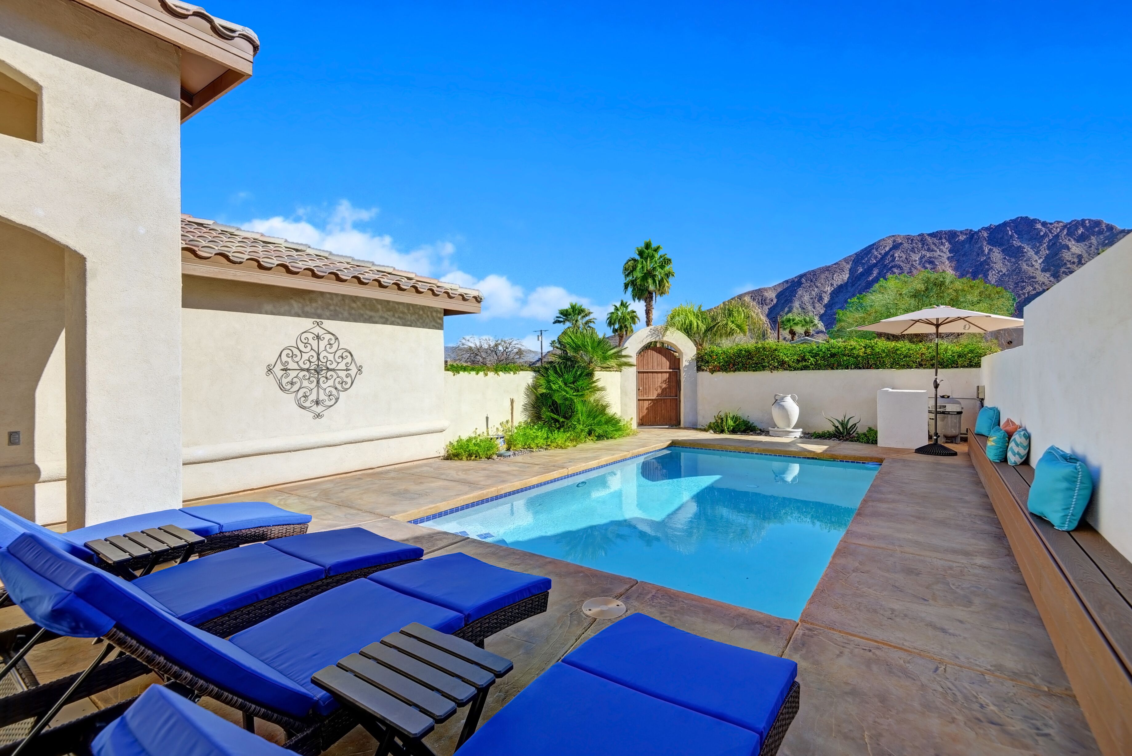 Desert retreat with spectacular Mountain Views, Spacious Pool, and Backyard.