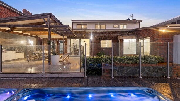 A modern house with a covered patio, a hot tub, and a brick exterior. - 10 Ocean Drive - one of those properties that  will have you never wanting to leave (Port Fairy)