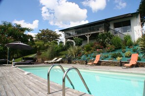 Seasonal outdoor pool, open 11:00 AM to 8:00 PM, pool umbrellas
