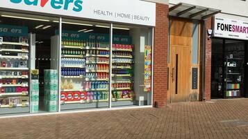 A storefront with 'savers' branding, featuring health, home, and beauty sections.