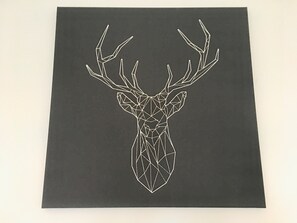 A geometric deer head design on a dark background.