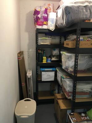 A storage room with shelves containing various items including boxes, bags, and containers. - Enjoy The Properties Of Living In The Center Of The City (Santiago Centro) (Santiago)