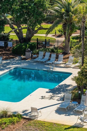 A swimming pool with lounge chairs and a fenced area. - Mariners Walk 10E in Wild Dunes- Ocean front 3 bedroom villa Isle of Palms with community pool. (Isle of Palms)