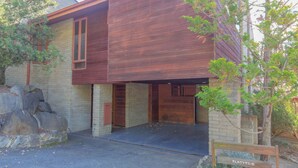 A modern building with a brick facade and wooden paneling.