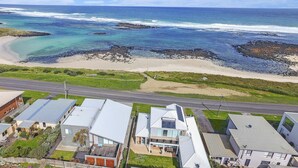A coastal residential area with houses, a beach, and a road. - A Top Deck - vast views of the Southern Ocean (Port Fairy)