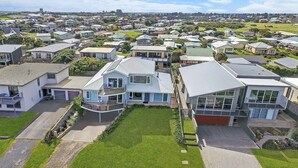 An aerial view of a residential area with modern houses, a well-maintained lawn, and a clear sky. - A Top Deck - vast views of the Southern Ocean (Port Fairy)