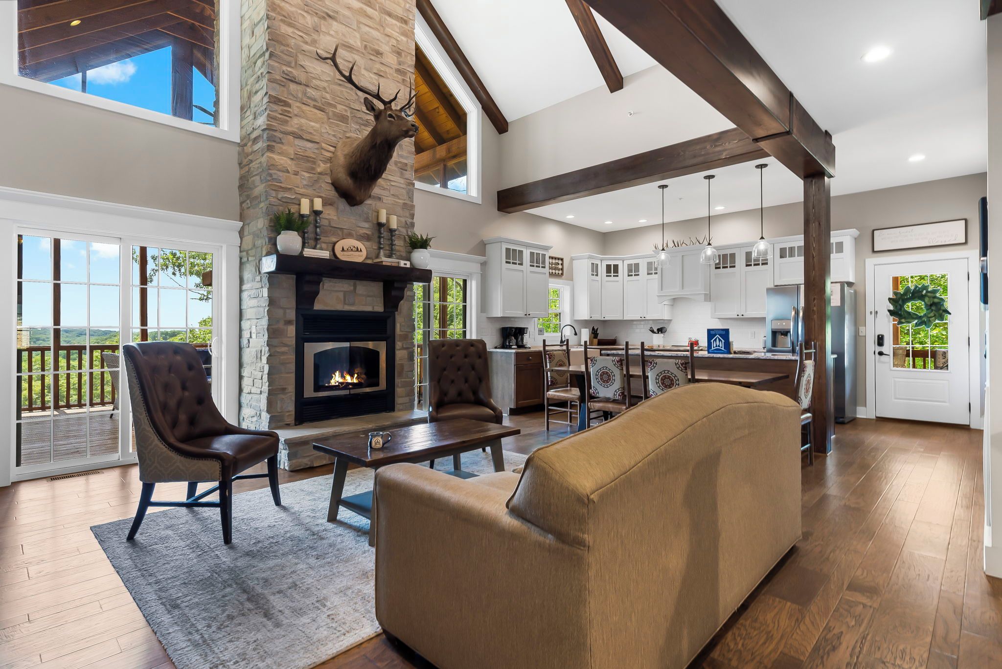 A spacious living room with a fireplace, a large sofa, and a dining area.