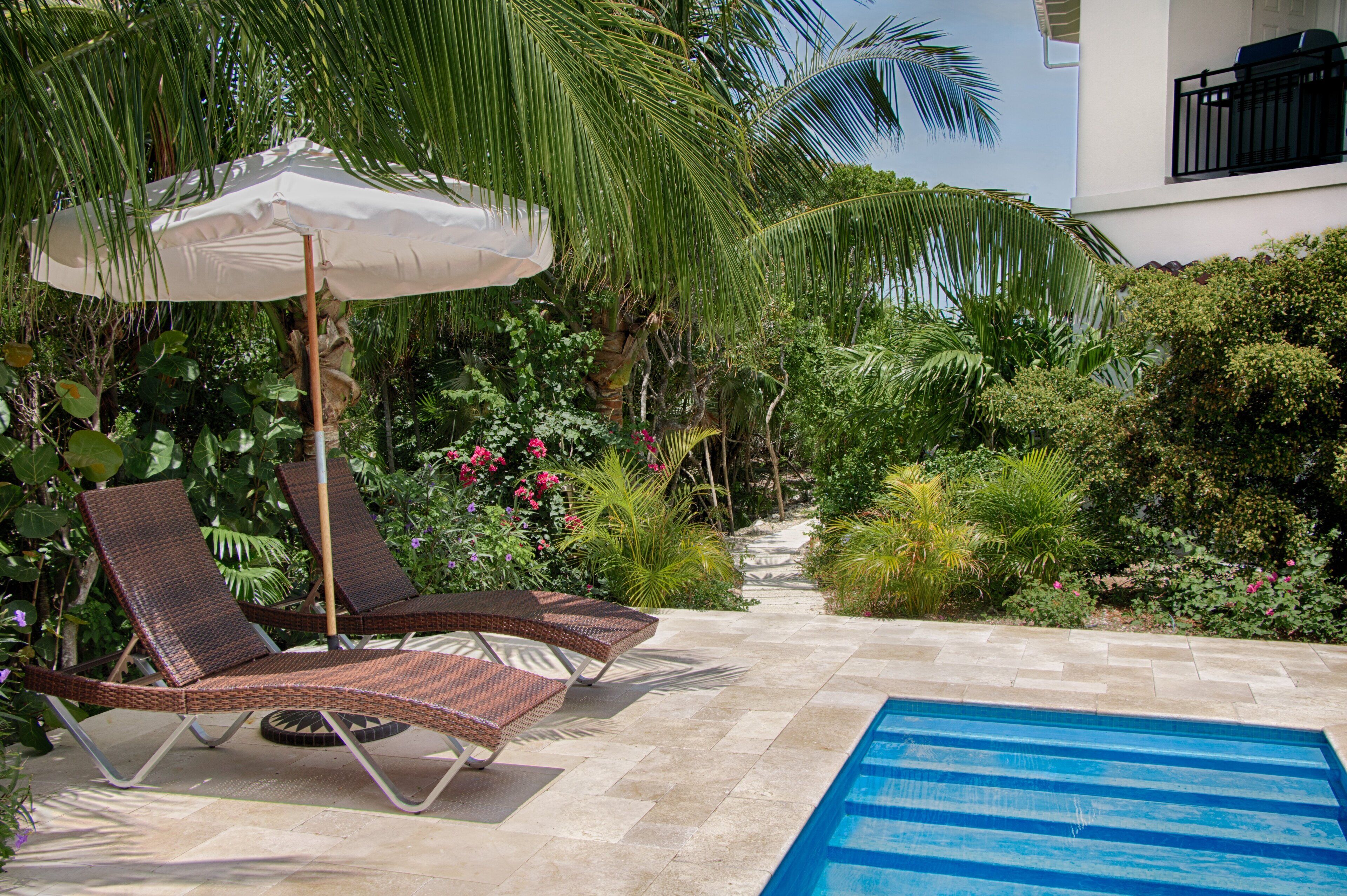 A poolside area with lounge chairs and a pool.