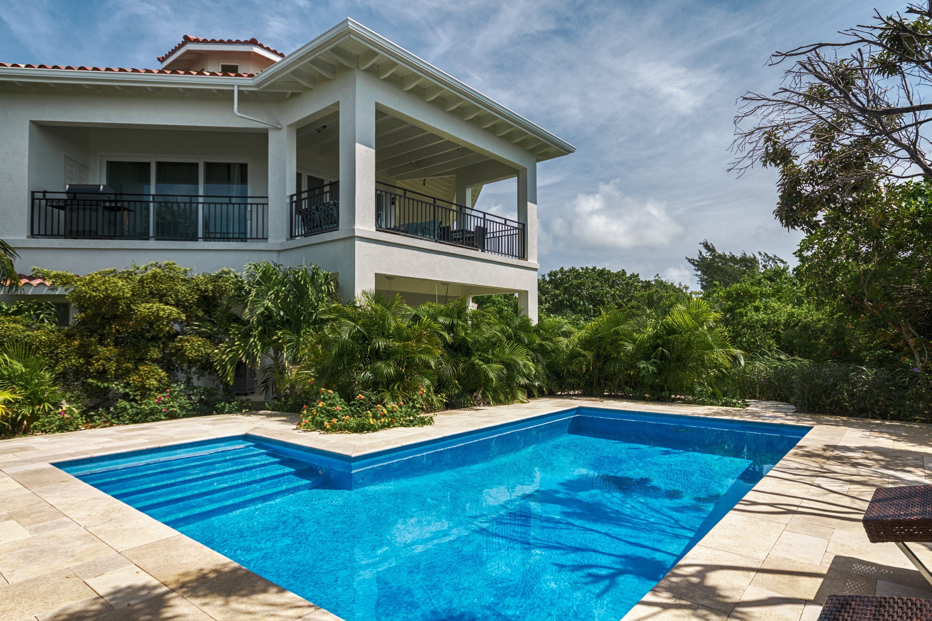 Take in the captivating sight of Villa Karana alongside the inviting outdoor pool, creating a picturesque setting for relaxation and enjoyment