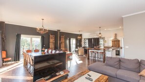 Enjoy a spacious living area with a central island, comfortable seating, and a well-equipped kitchen.