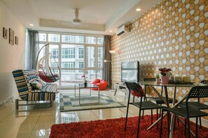 Relax in this stylish living room with a city view, featuring a sofa, bean bag chair, and dining area.