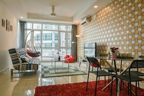 Relax in this stylish living room with a city view, featuring a sofa, bean bag chair, and dining area.