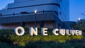 A modern building with the sign "ONE CULVER" in large letters. - Remodeled Designer Cottage with Bicycles (Culver City)