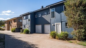 Stunning two-story home with a garage and beautifully manicured lawn.