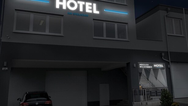 A modern hotel building with a prominent "HOTEL" sign and "AM SPIELACKER" text. - Hotel Am Spielacker (Gelnhausen)