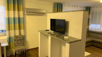 Deluxe Penthouse, 1 Queen Bed with Sofa bed | Living area | Flat-screen TV