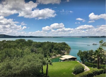 View of the backyard, cove, and dock with Lake Travis' main basin in background