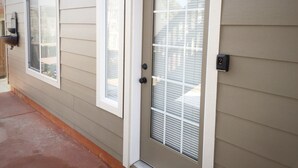 A house with a front door, two windows, and a mailbox.