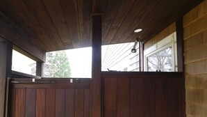 A wooden interior with a high ceiling and a window. - Menemsha Home Fully Renovated w/ Amazing Waterview's of Vineyard Sound (Menemsha)