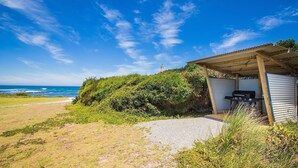 A beachside property with a covered outdoor area, a barbecue grill, and a view of the ocean. - Wytonia 2 - Ocean Views From Your Bed (Port Fairy)